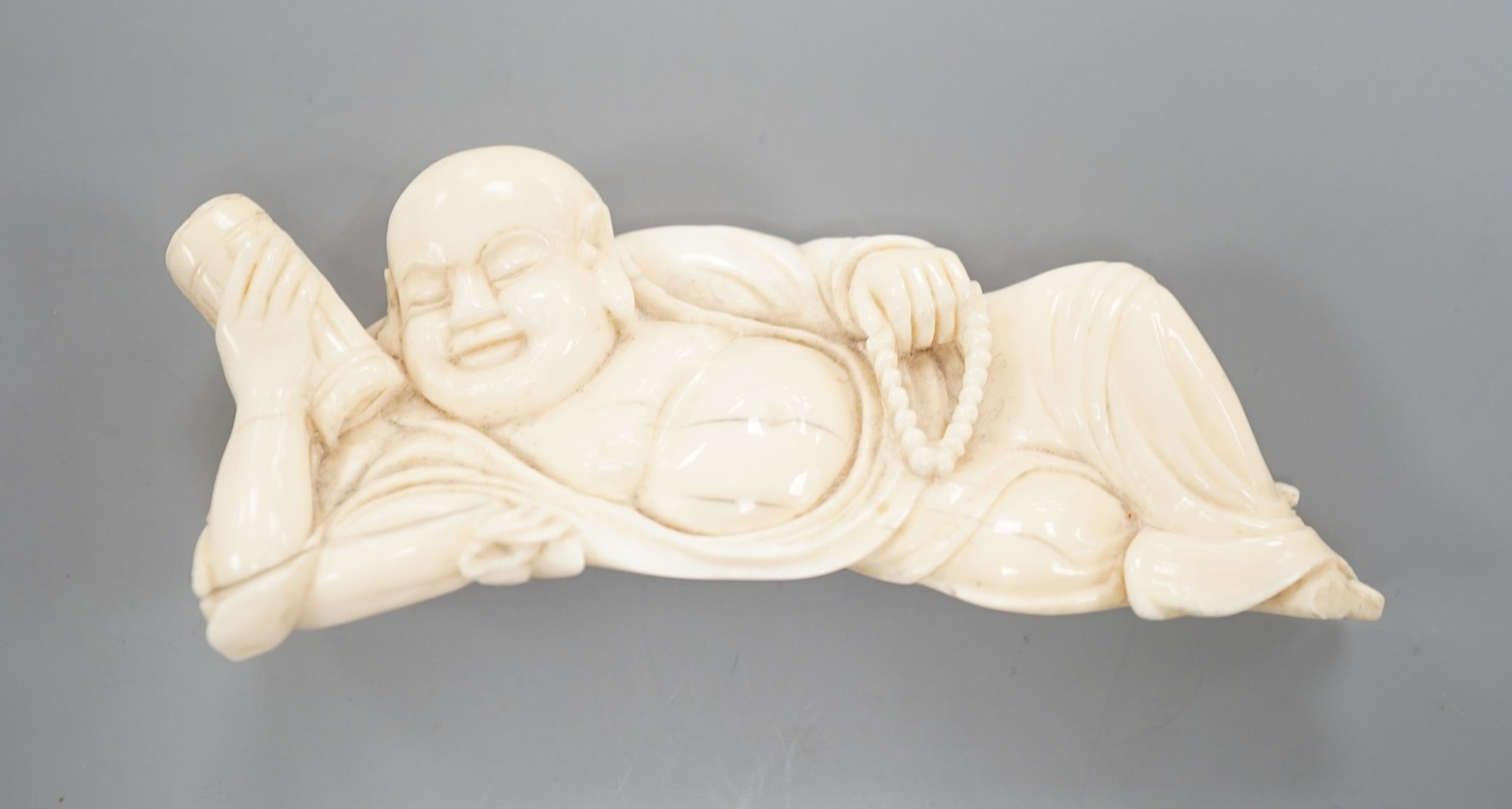 A 19th century Chinese carved ivory figure of Budai 11cm